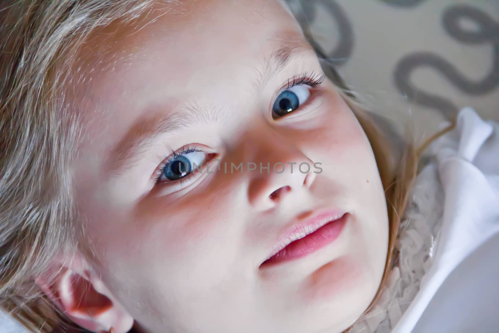 Cute girl with blond long hair and blue eyes