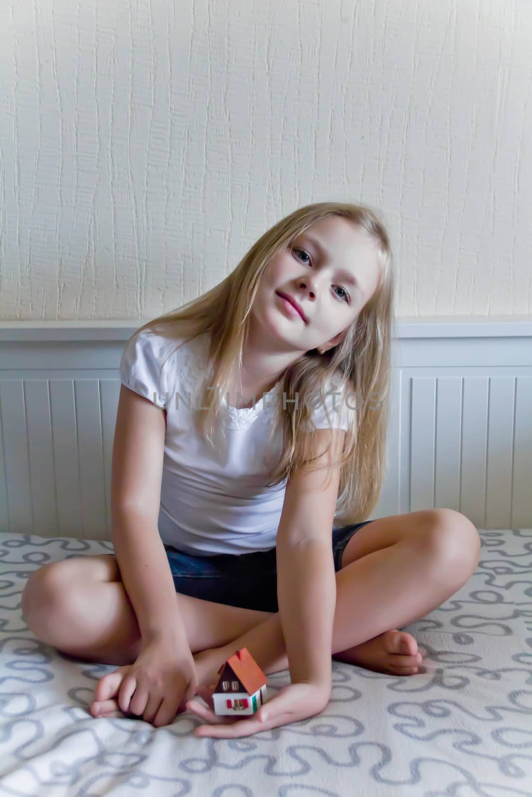 Cute girl with blond long hair and blue eyes