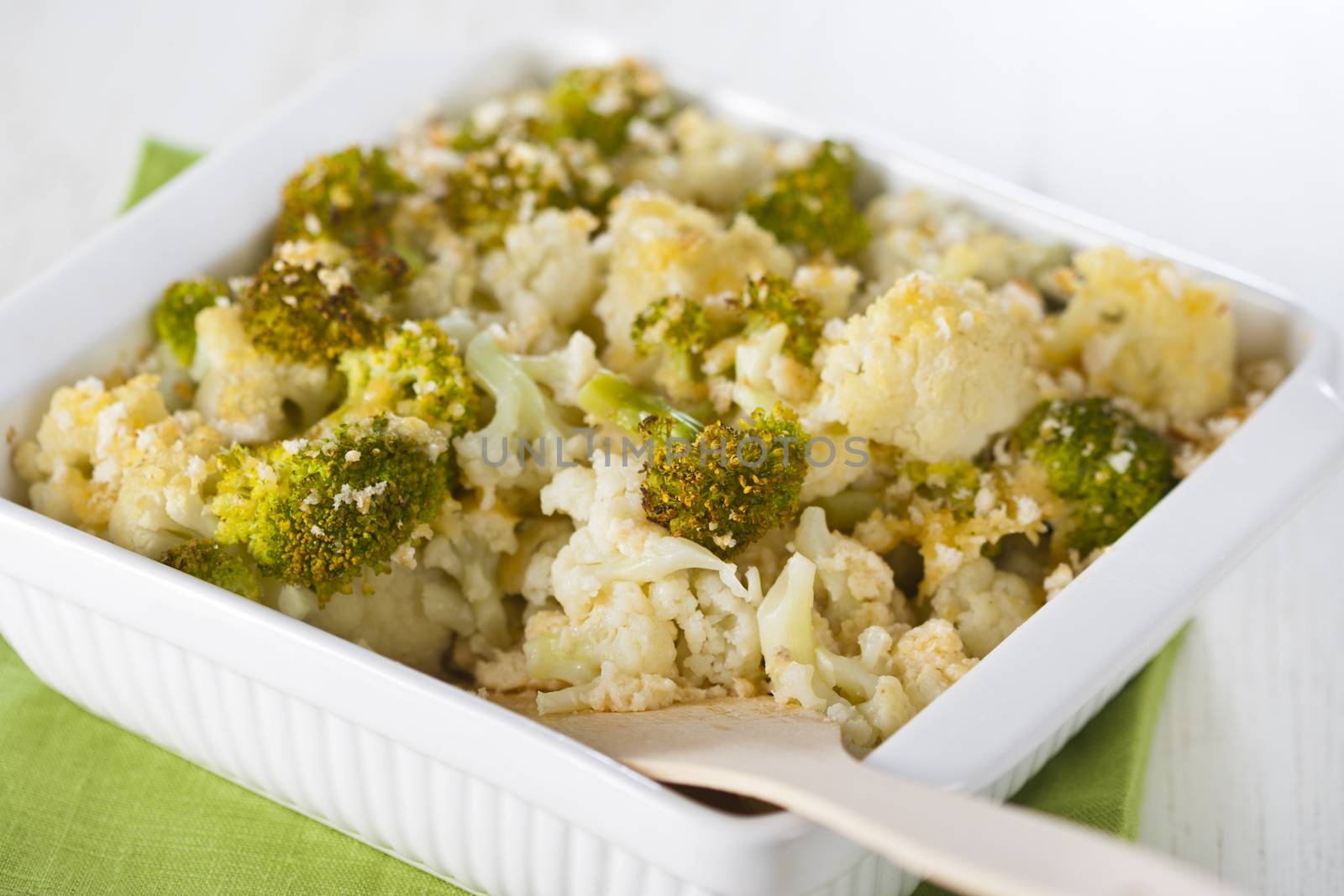 Broccoli and cauliflower gratin in white casserole 