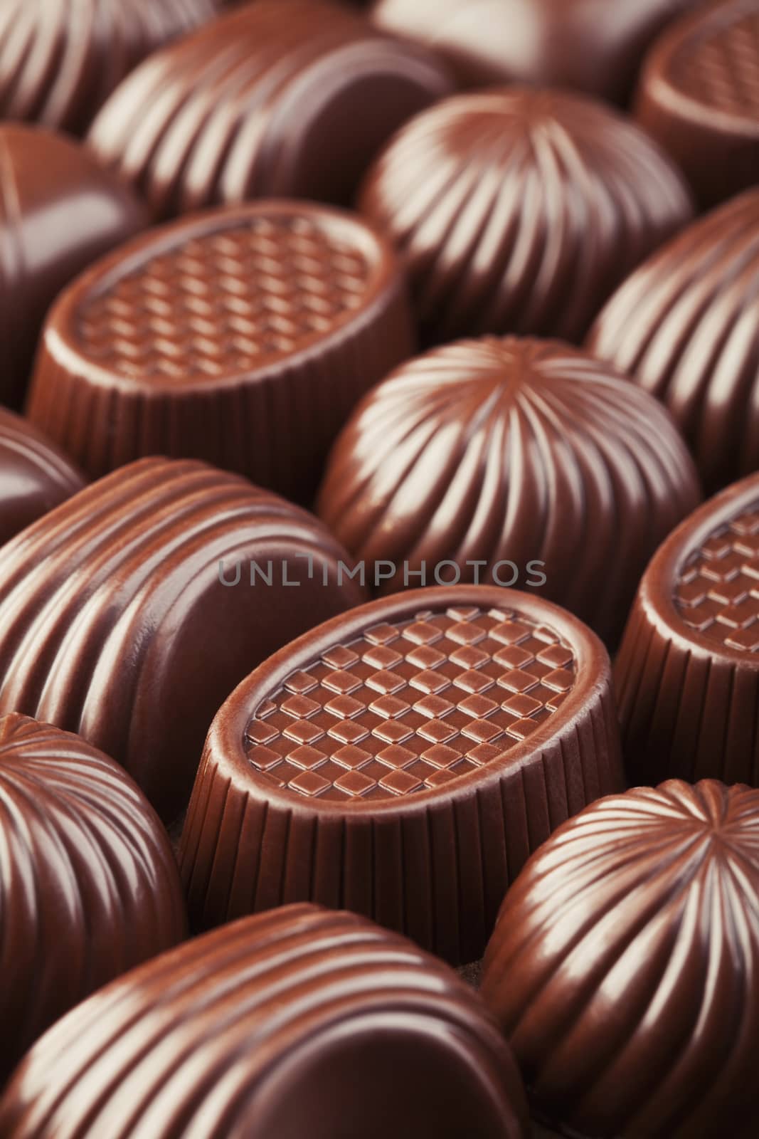 Assorted delicious brown tasty chocolate pralines background