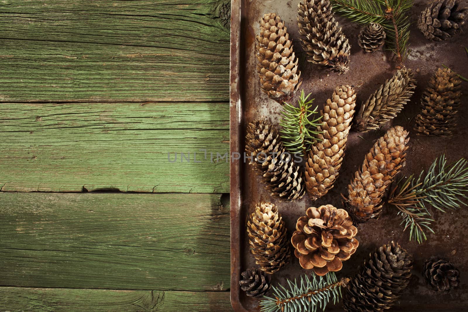 Christmas fir cones on vintage green wooden background