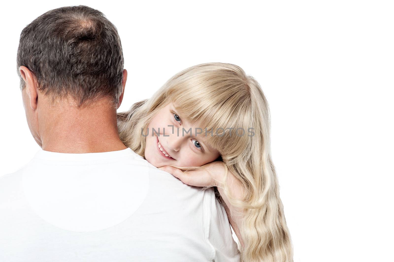 Cute little girl posing to camera when her father holds her 