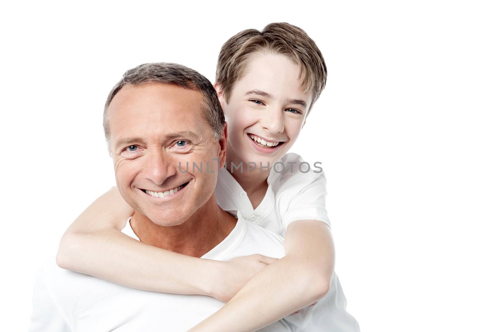 Smiling father holding son on his shoulders by stockyimages