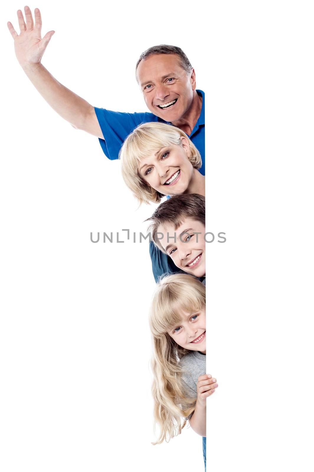 Smiling father raising his arm, family posing together