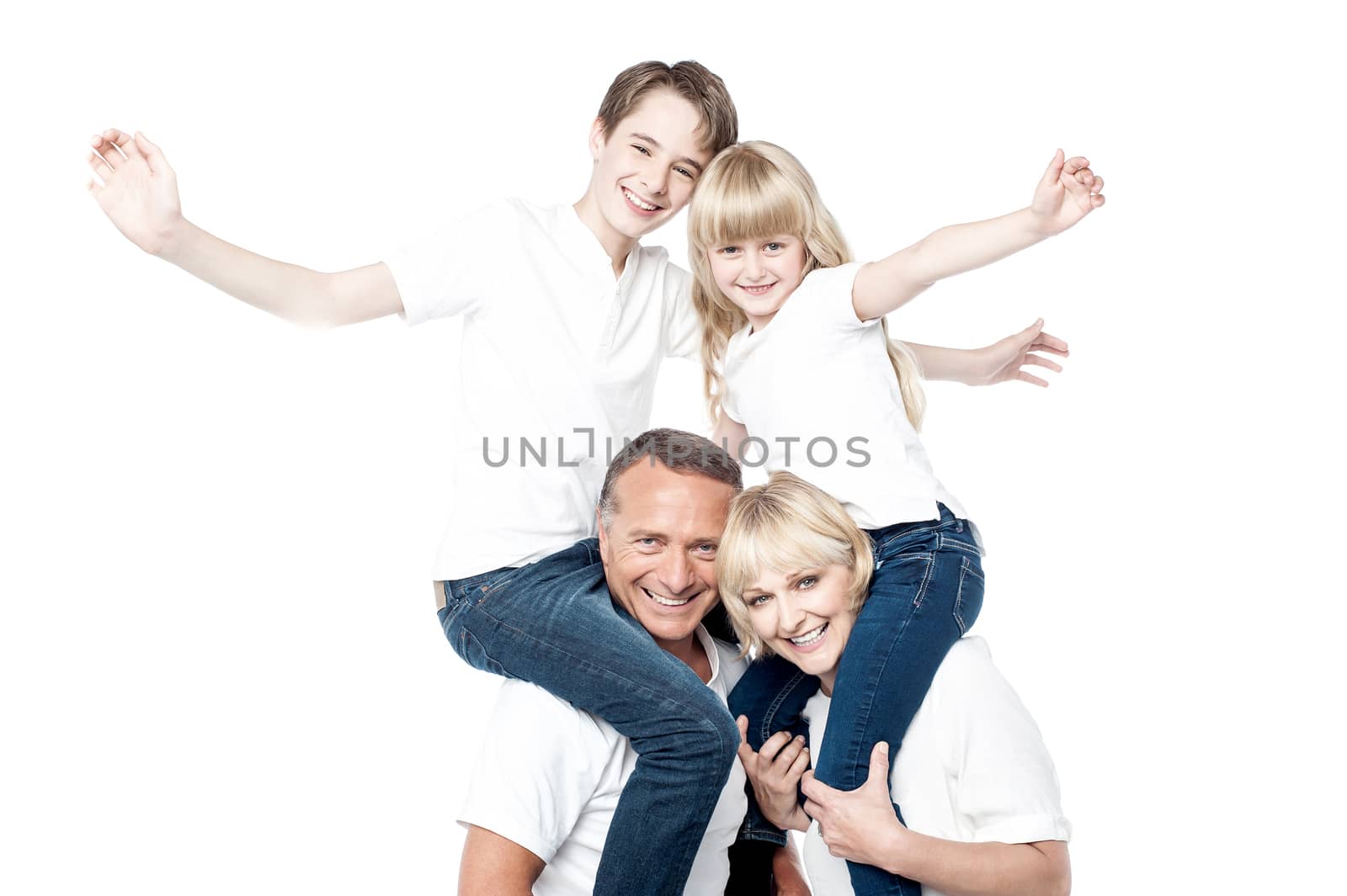 Couple carrying their children on shoulders