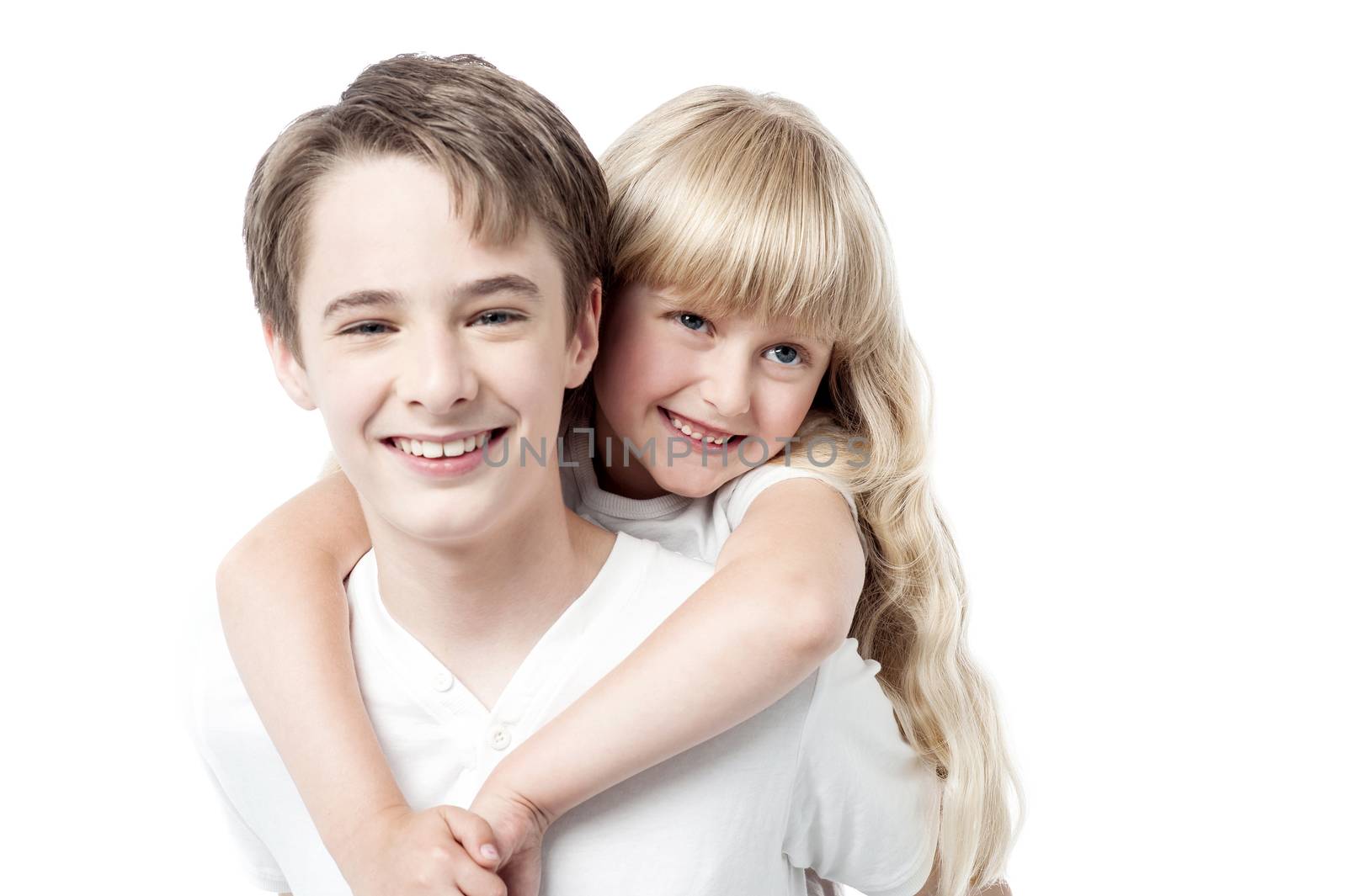 Young boy giving little girl piggyback ride by stockyimages