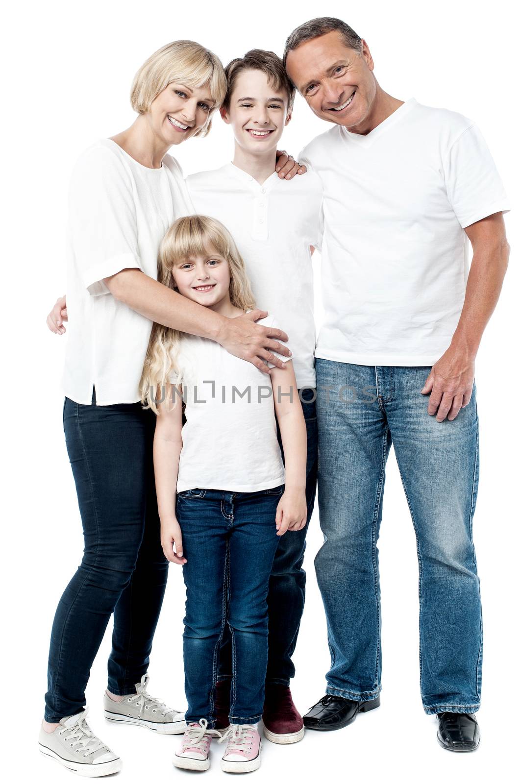 Happy couple with cheerful children by stockyimages
