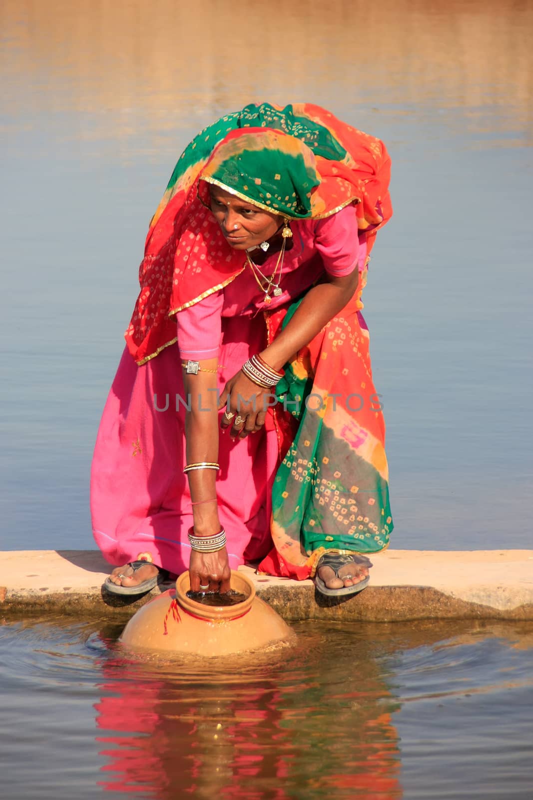 Local woman getting water from reservoir, Khichan village, Rajasthan, India