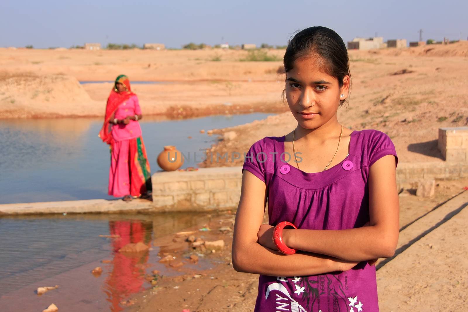 Local girl standing near water reservoir, Khichan village, Rajasthan, India