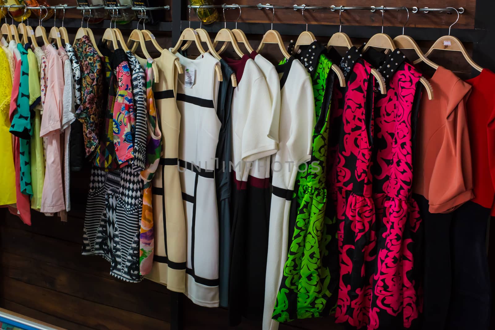 Colorful blouse hanging on clothesline in a shop.