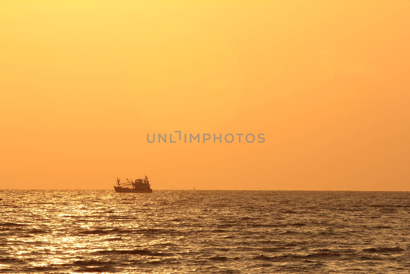Fisherman boat at sunrise by wyoosumran