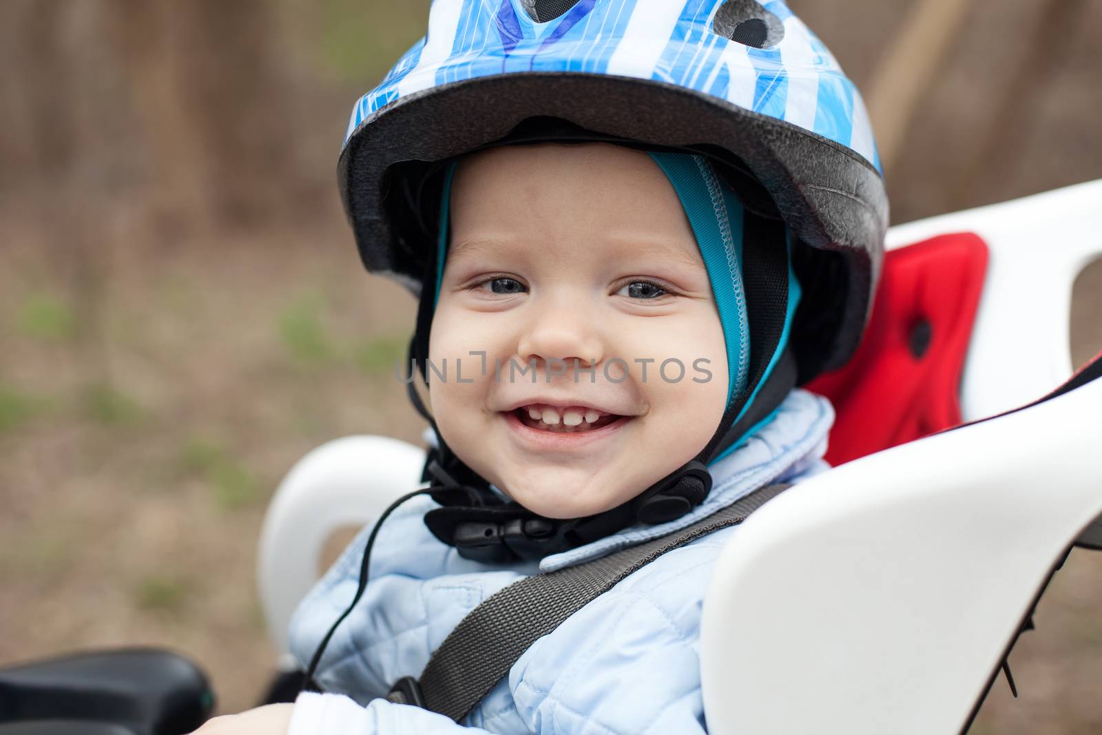 Cute smiling little boy in bicycle seat