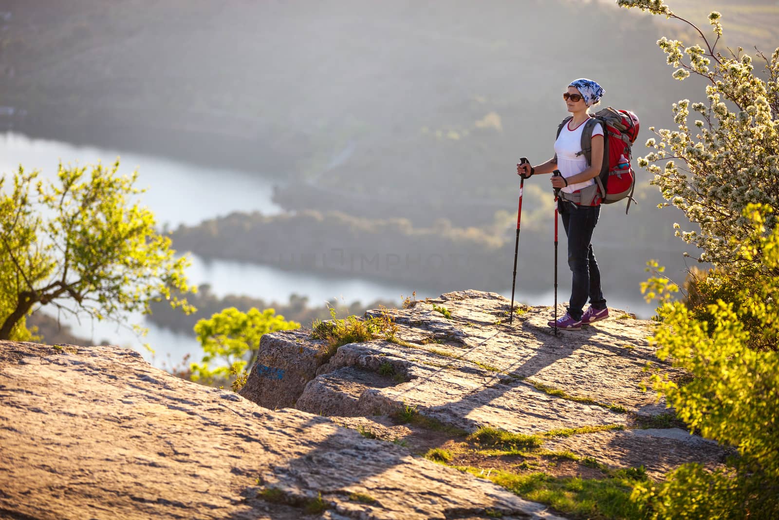 Hiker on cliff and enjoying valley view by photobac