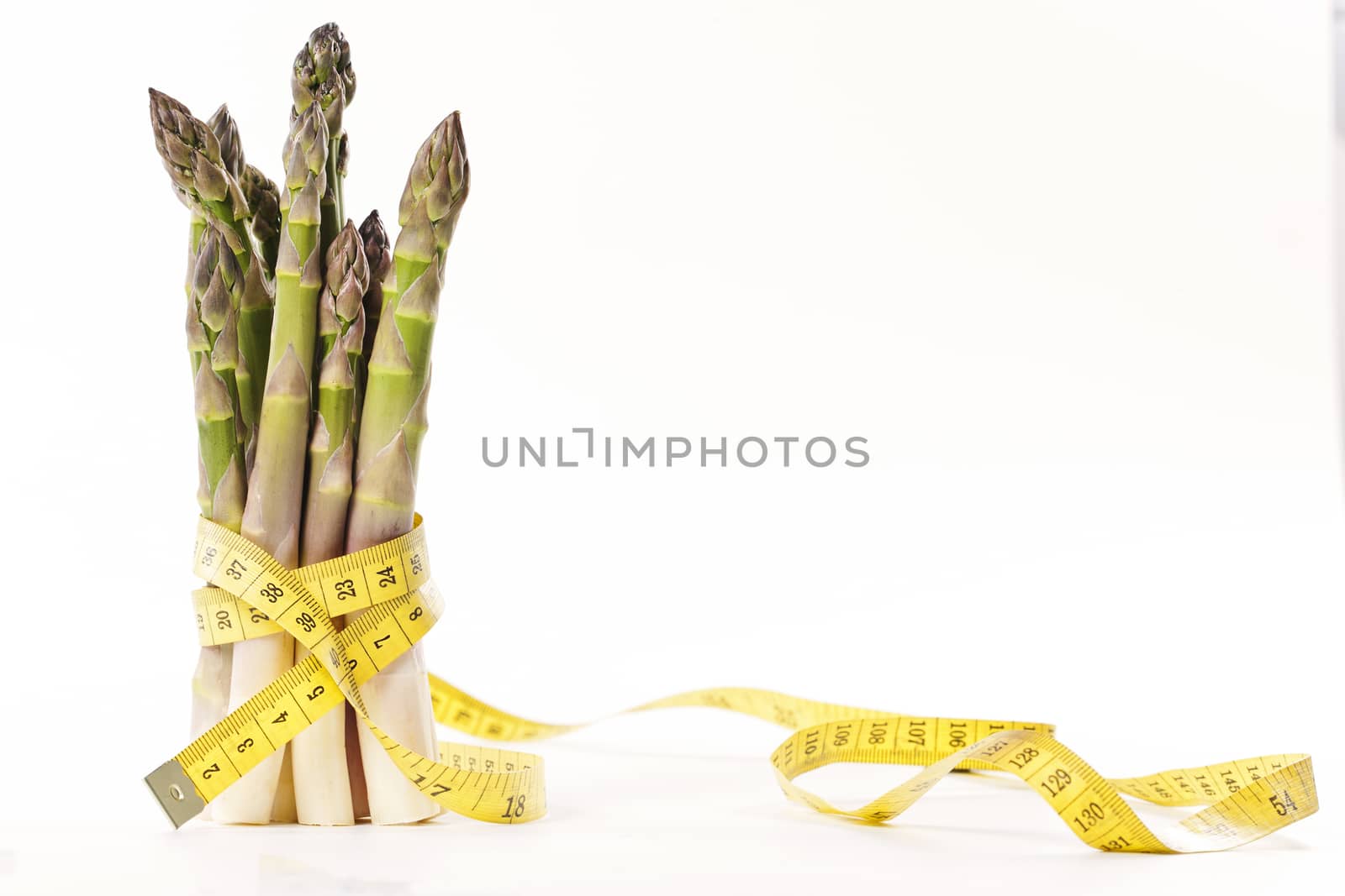 Asparagus and measuring type on a white background