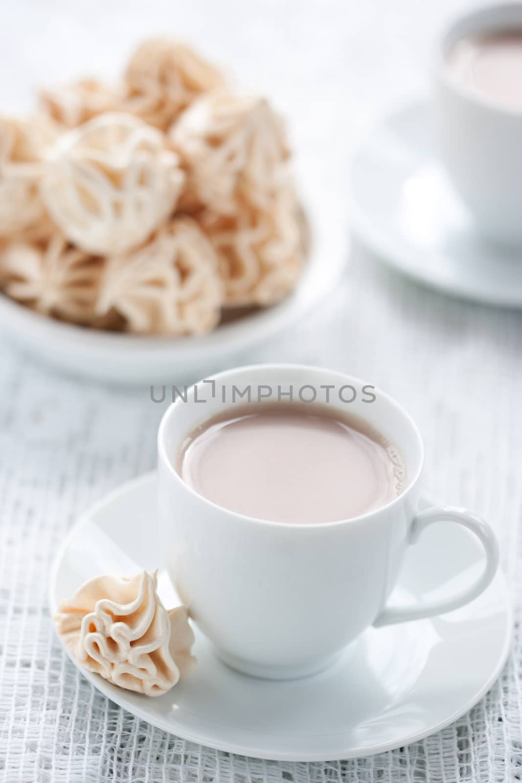 Meringues and cup of chocolate drink, shallow dof.