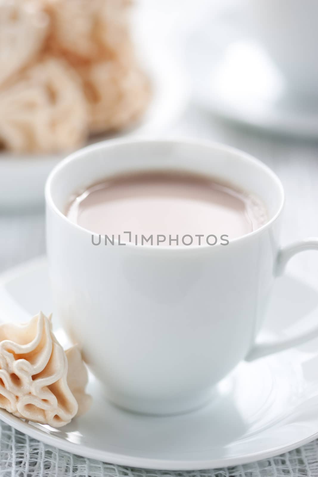 Meringues and cup of chocolate drink, shallow dof.