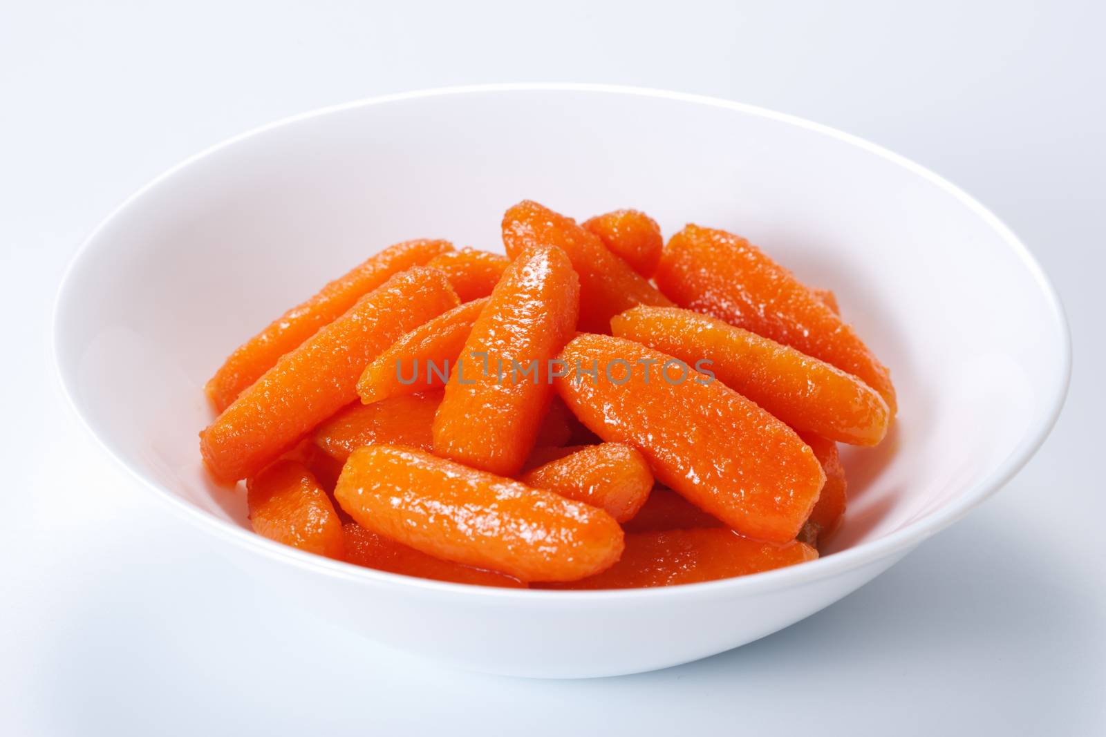 Honey glazed baby carrots in bowl