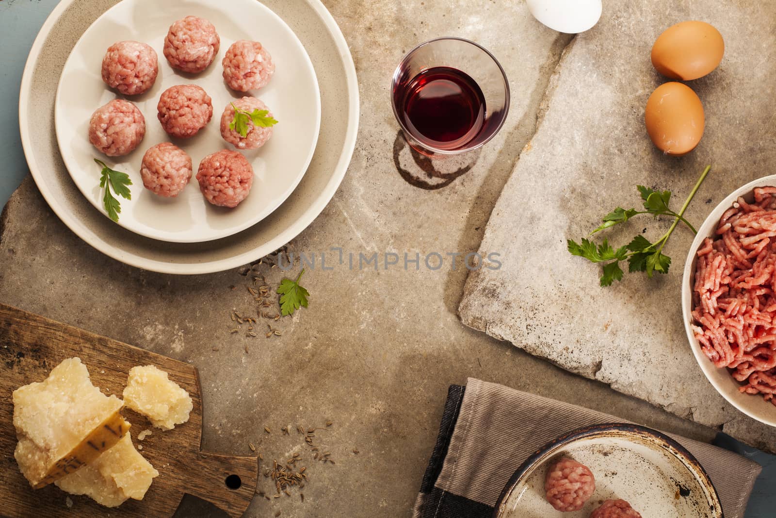 Meatballs cooking with mince, parsley, parmesan, wine and eggs.