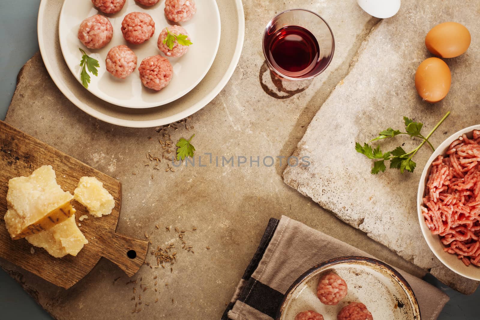 Meatballs cooking with mince, parsley, parmesan, wine and eggs.