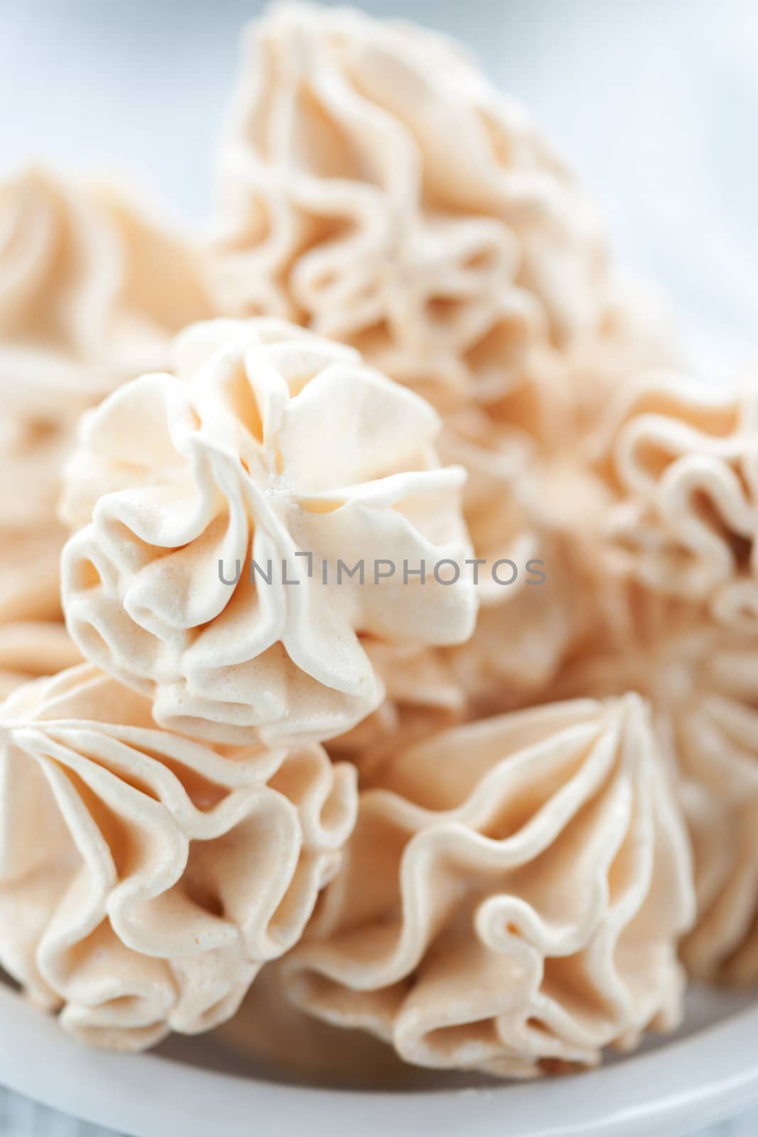 Meringues on white background, shallow dof.