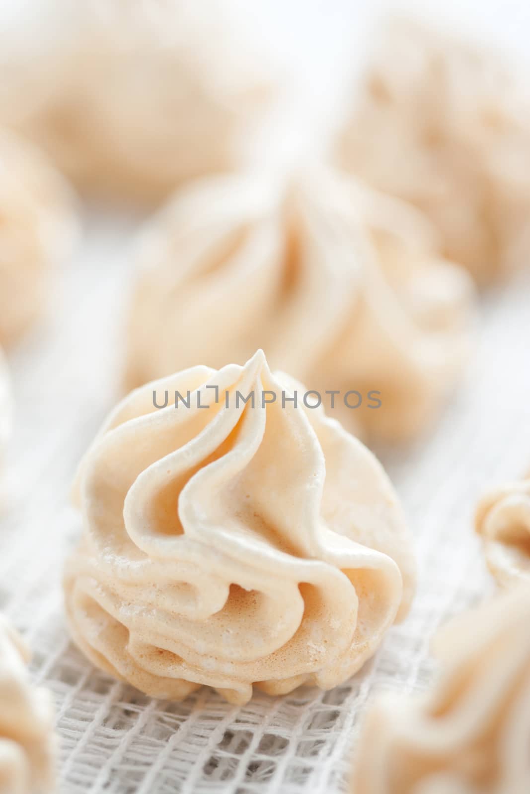 Meringues on white tablecloth, shallow dof.