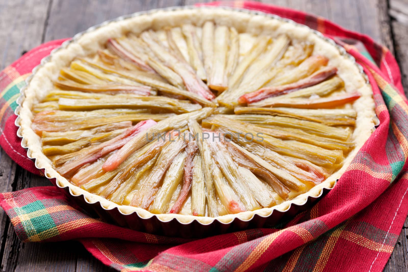 Delicious rhubarb pie on rustic background