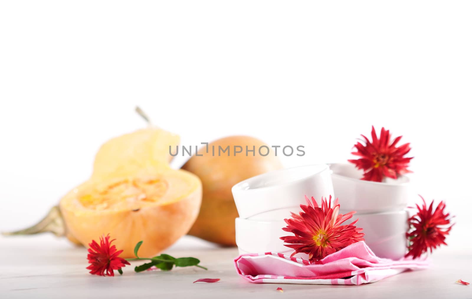 Pumpkins, cooking utensil and autumn flowers.