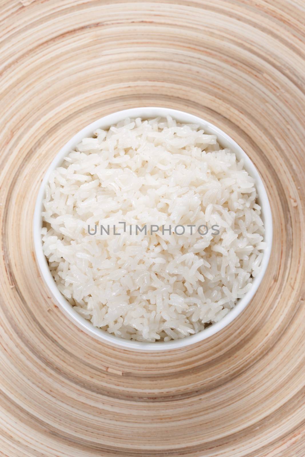Rice in a bowl on a bamboo plate. Concept of the importance of rice