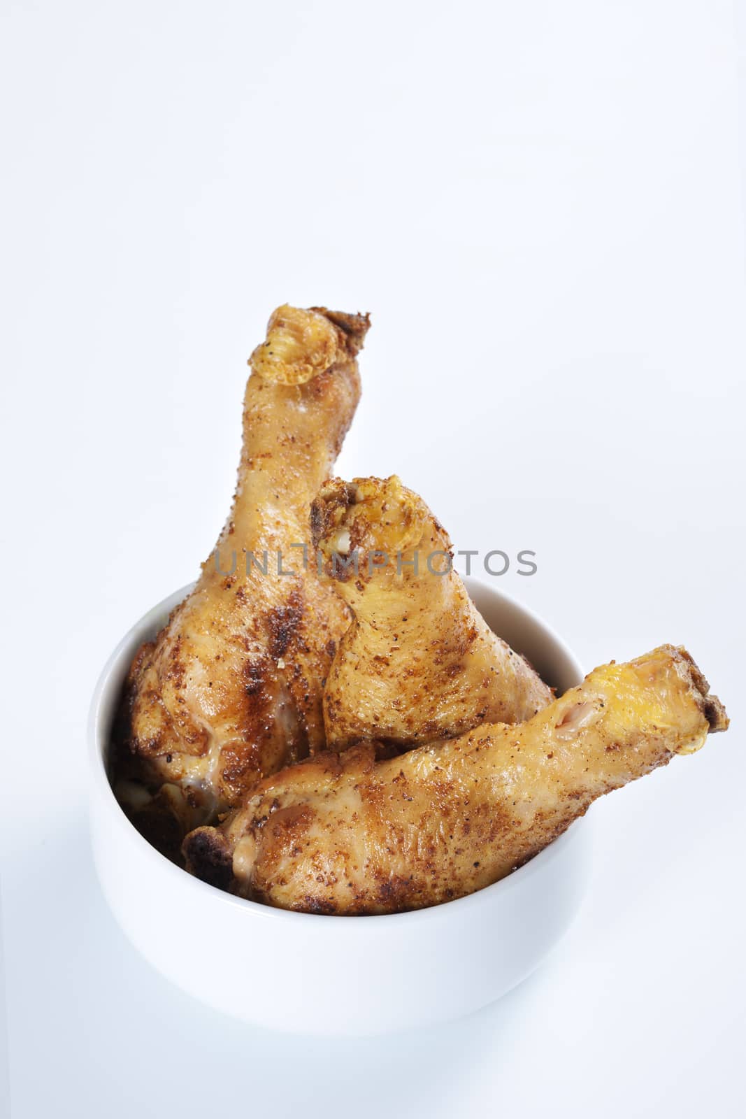 Roasted chicken legs in a bowl