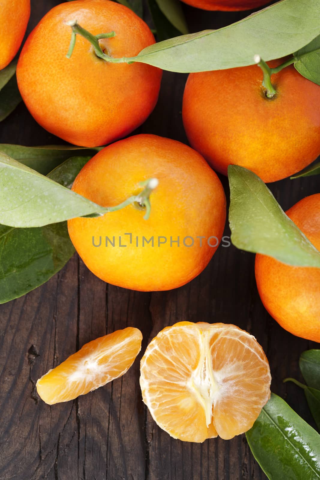 Ripe tangerines on a wooden table