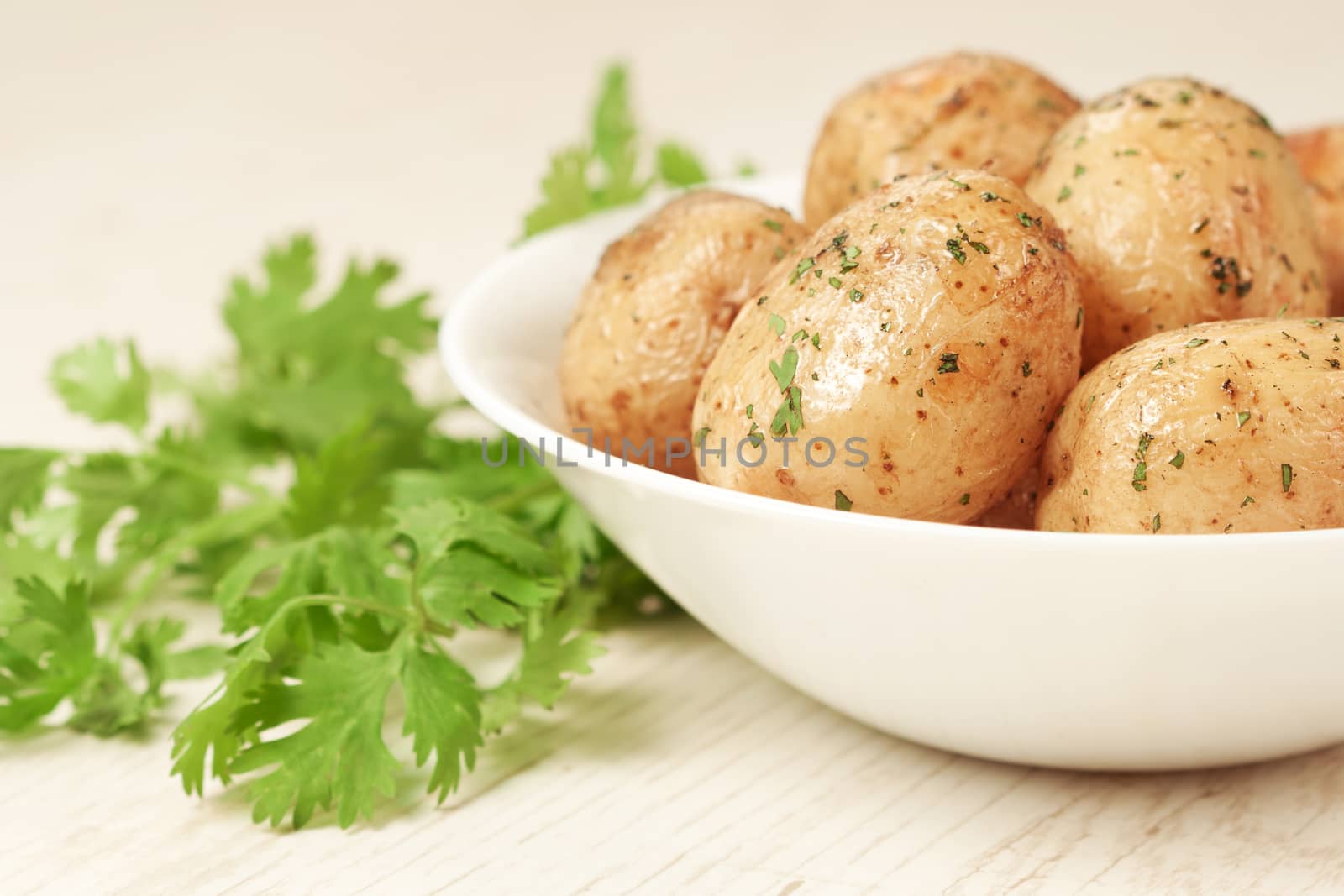 Roasted potatoes with parsley in bowl