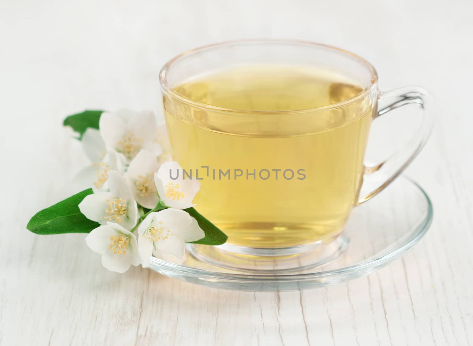 Green tea with fresh jasmine flowers. 