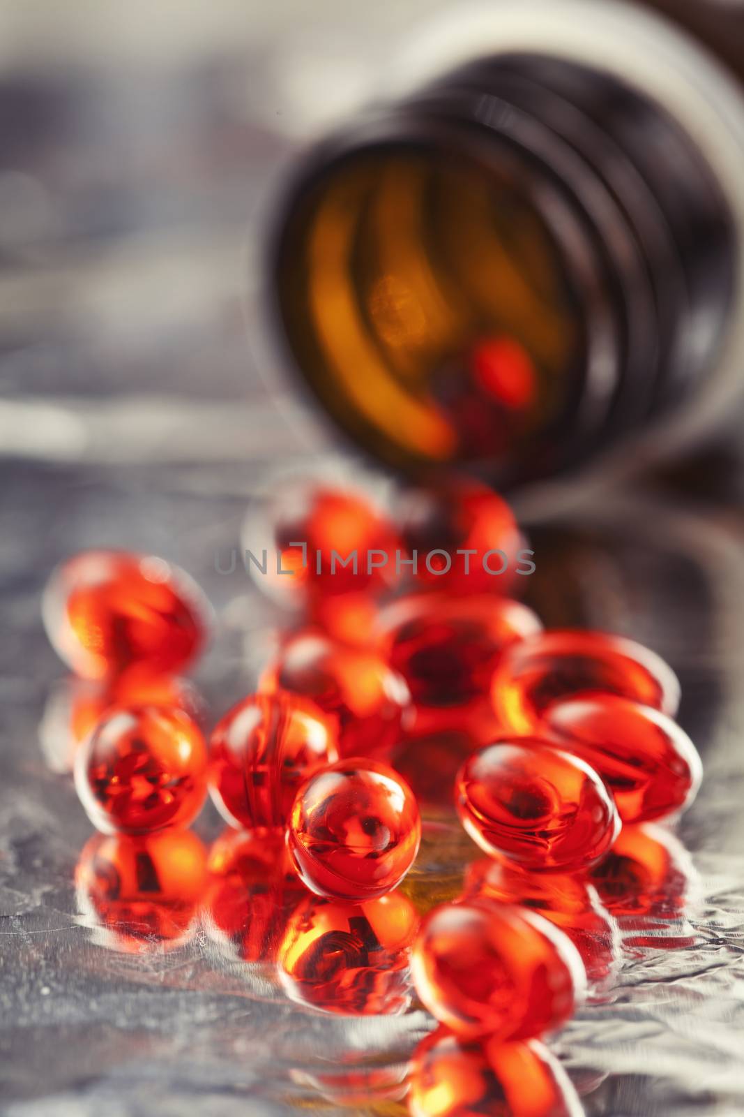 Orange vitamin pills and pill bottle