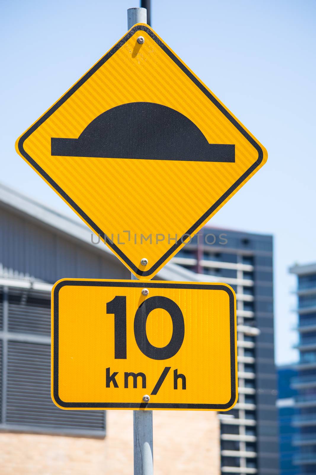 Speed Limit 10 sign on the road in front of buiding, Australia