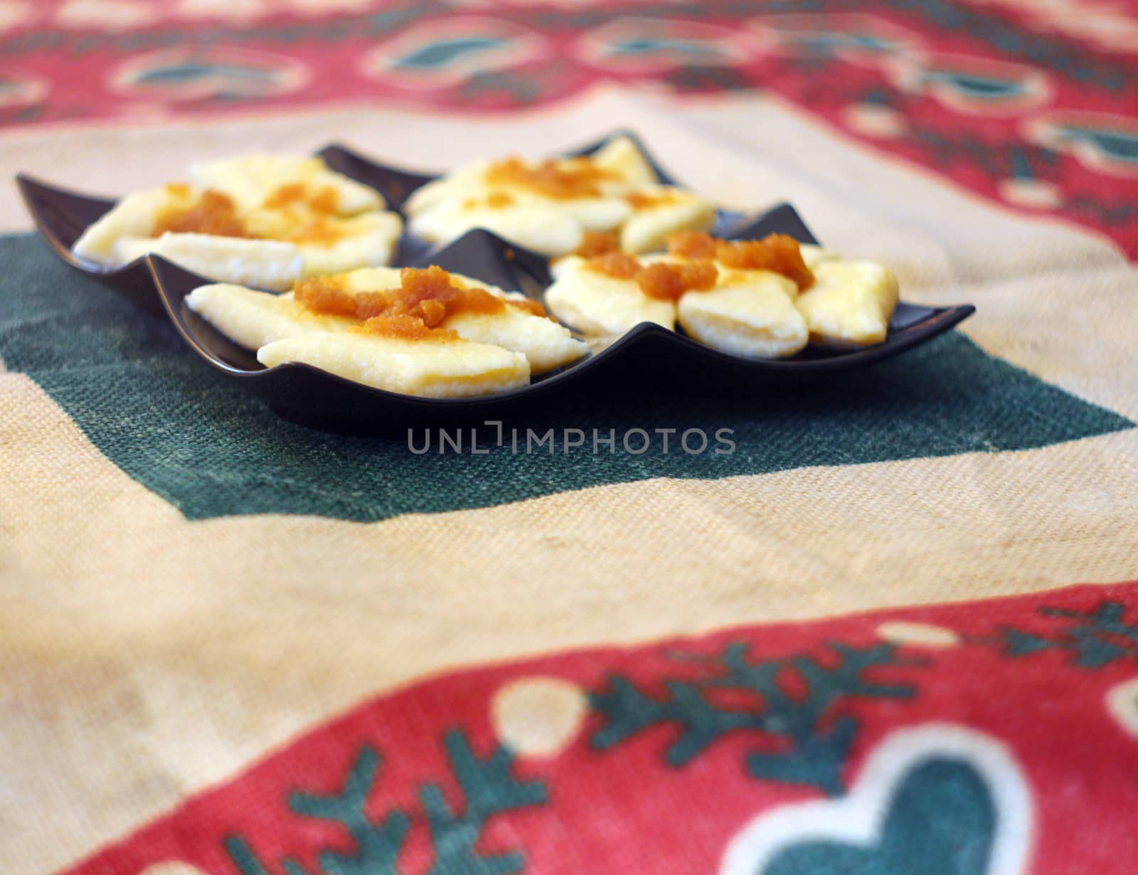 Cooked traditional lazy noodles with crumbs on black plate by sanzios