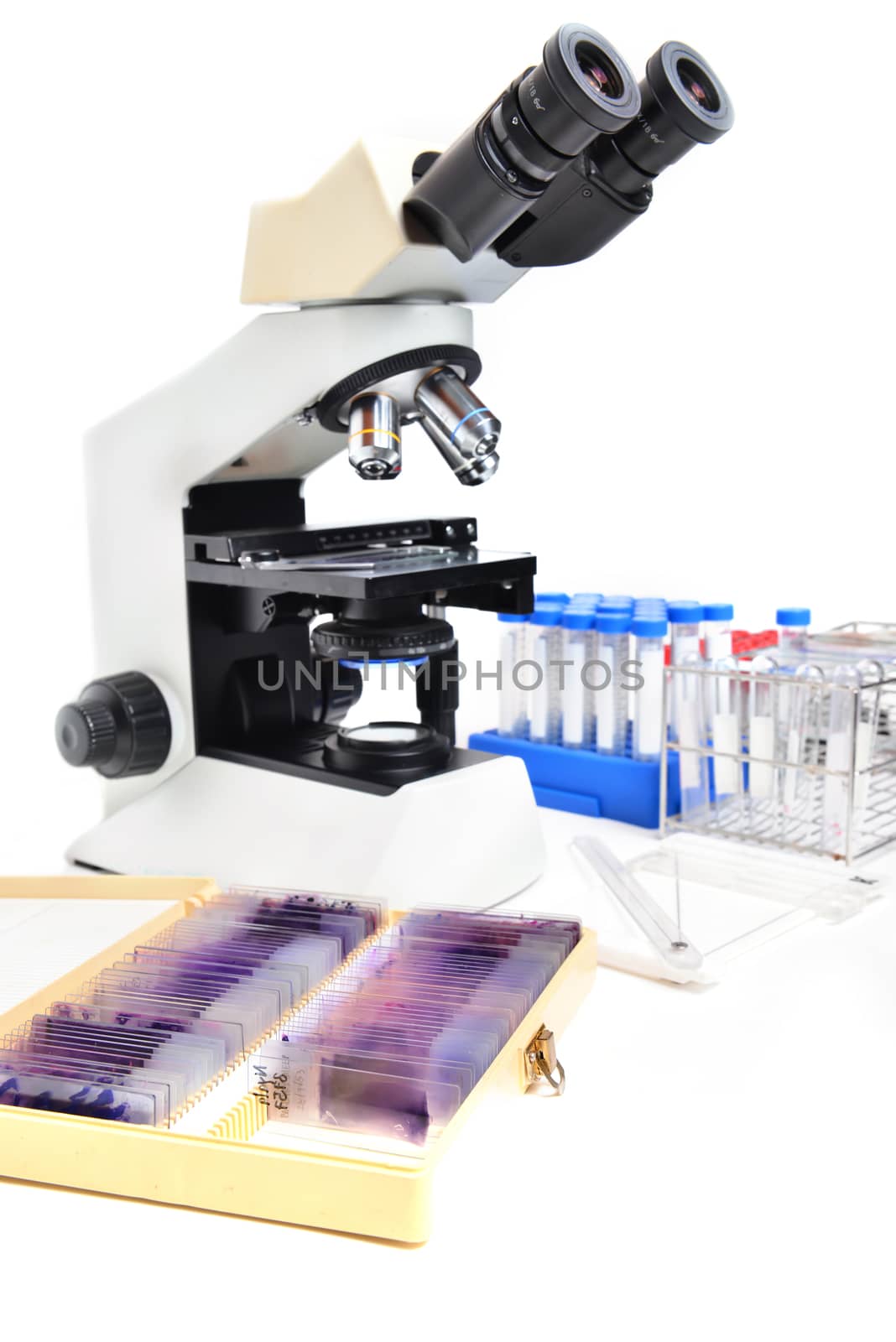 microscope with laboratory equipment on white background