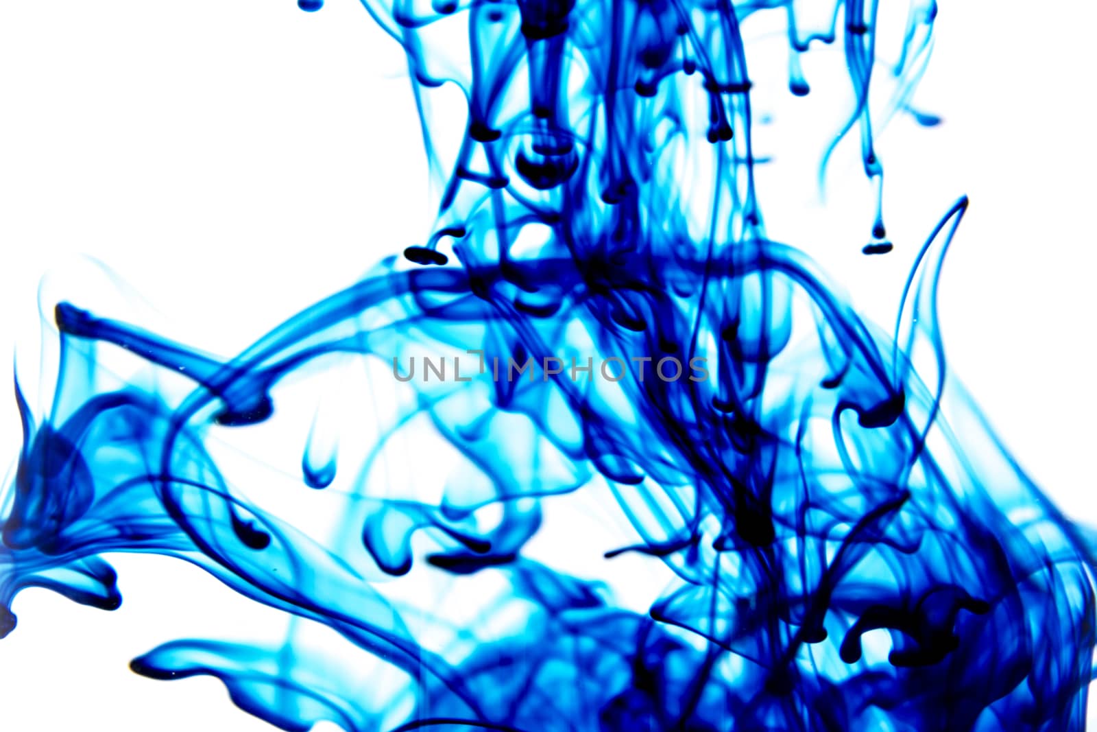 Vegetable ink poured into water with white background.