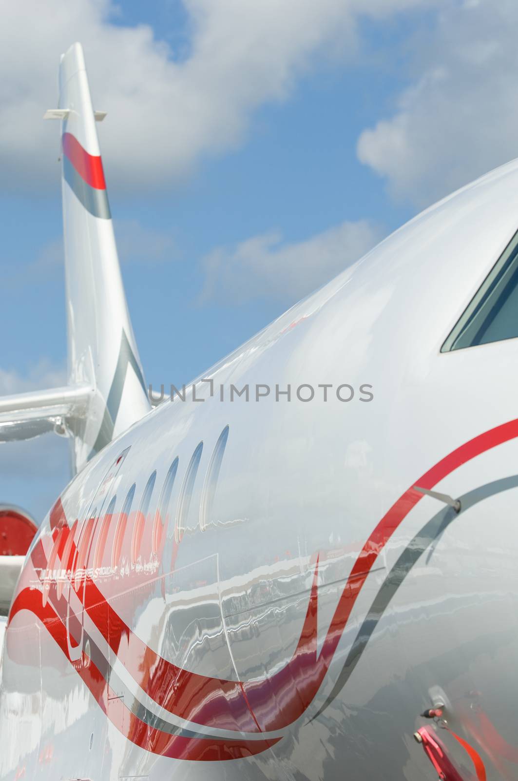 Detail of white and red corporate jet airplane