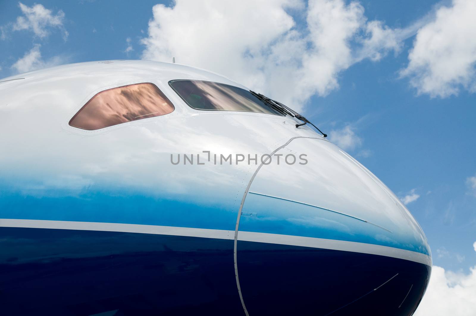 Front detail with cockpit windows of passenger wide-body jet airplane