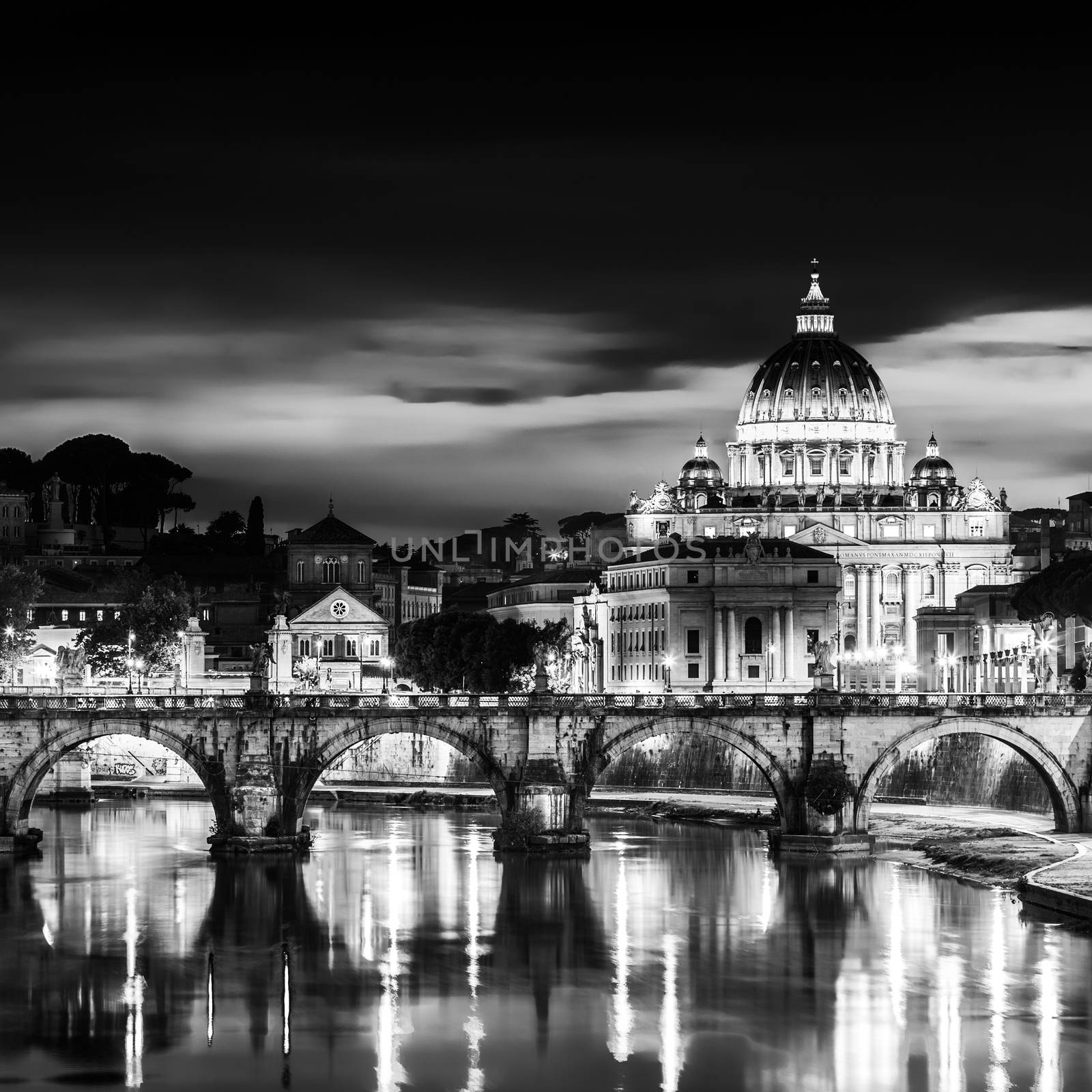 Night view of old roman Bridge of Hadrian and St. Peter's cathedral in Vatican City Rome Italy.