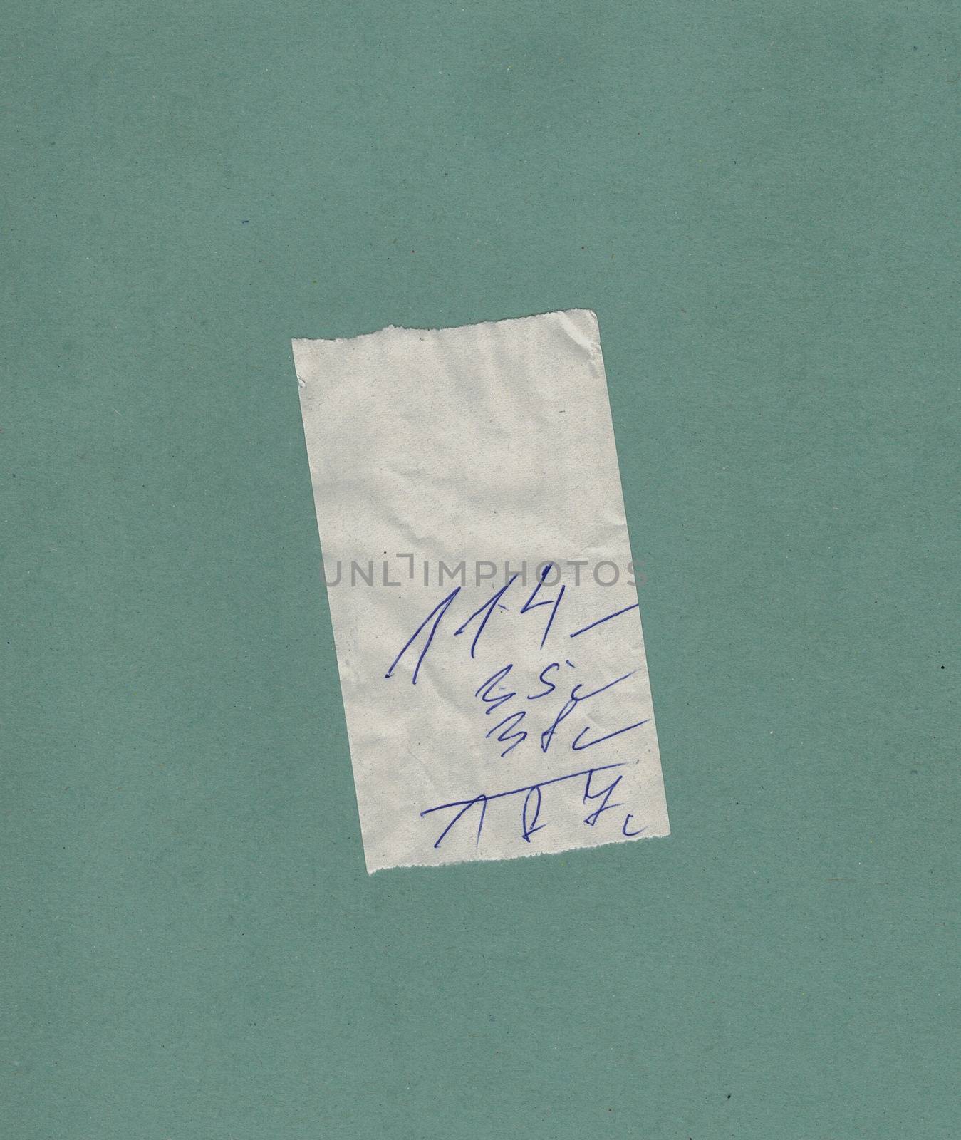 handwritten bill or receipt isolated over green blue background