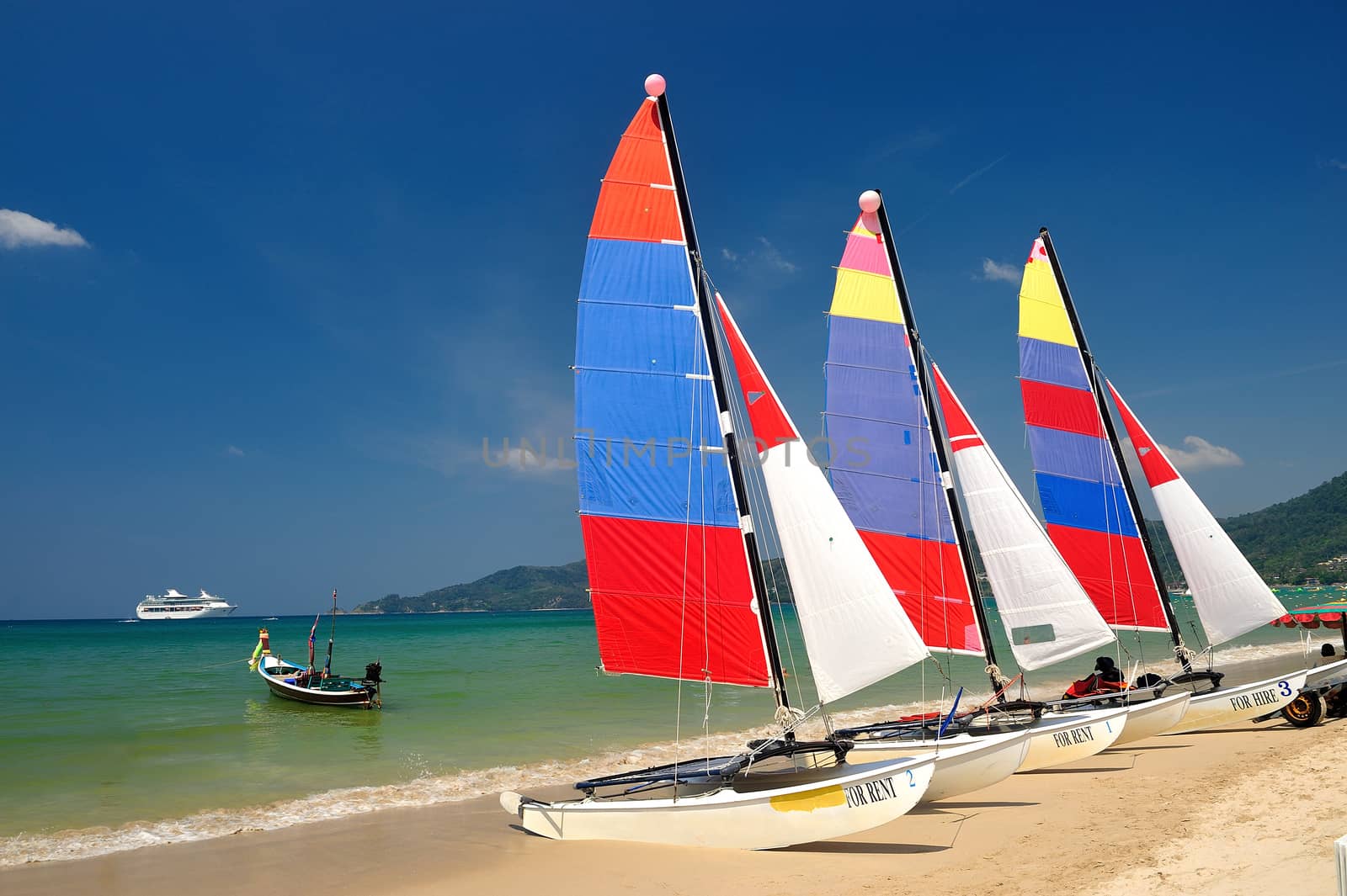 sail boat on patong beach, phuket, thailand by think4photop