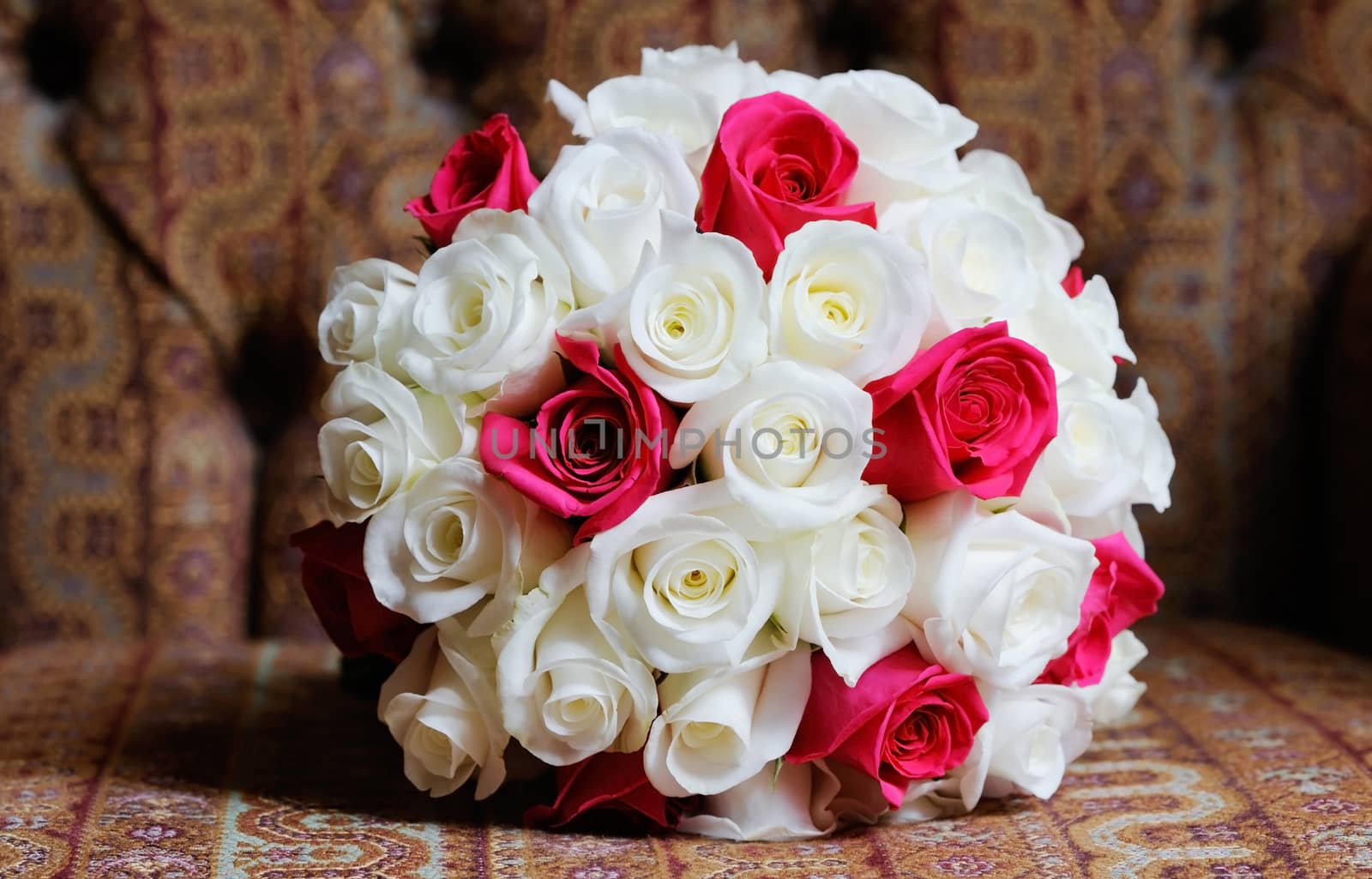 Brides red and white roses on wedding day in a floral arranagement showing closeup detail