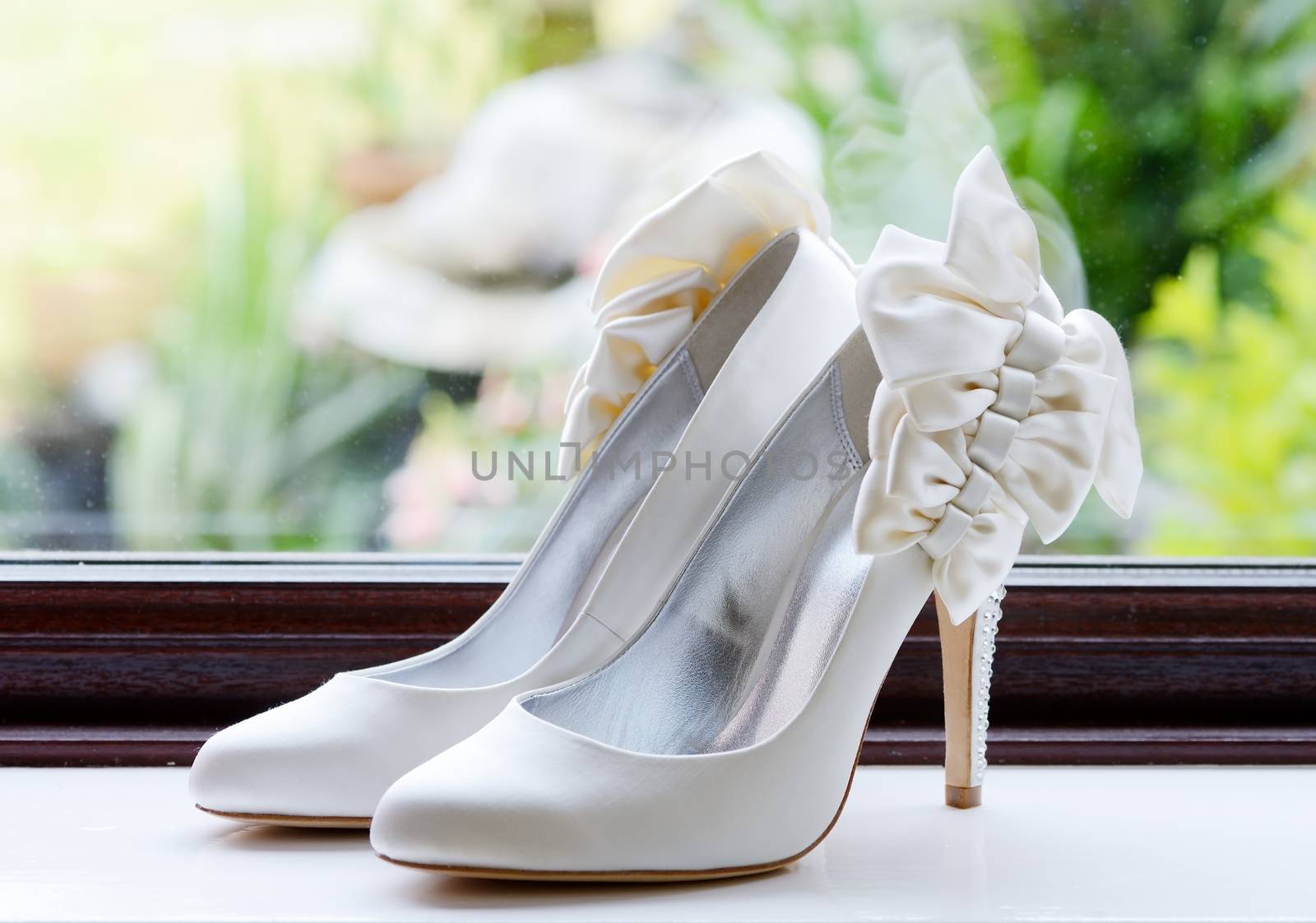 Brides shoes closeup on wedding day by a window