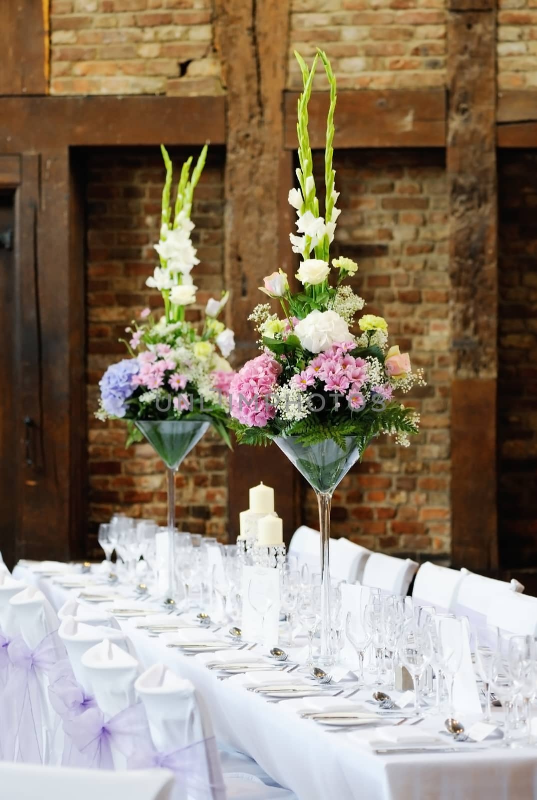 Wedding reception flower arrangement with pink and white decoration on table