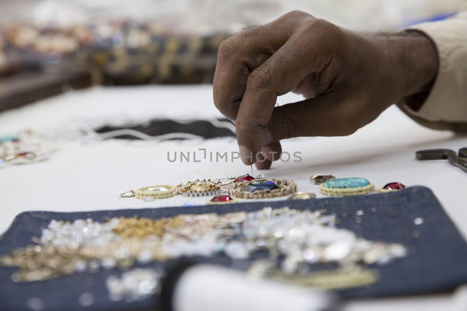 Tailor sewing embroidery close up  by haiderazim