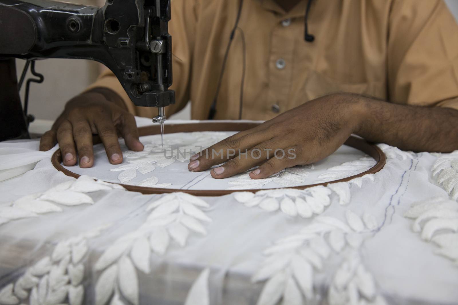 Tailor sewing on machine