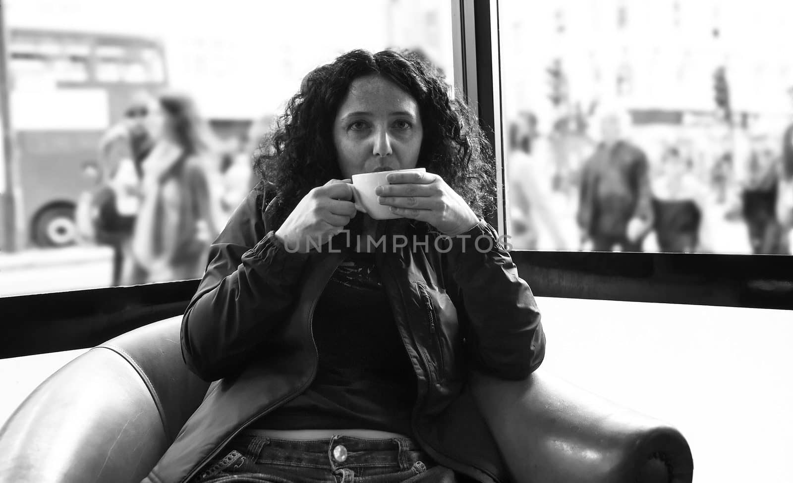 Pretty young brunette girl woman female drinking a cup of coffee or tea