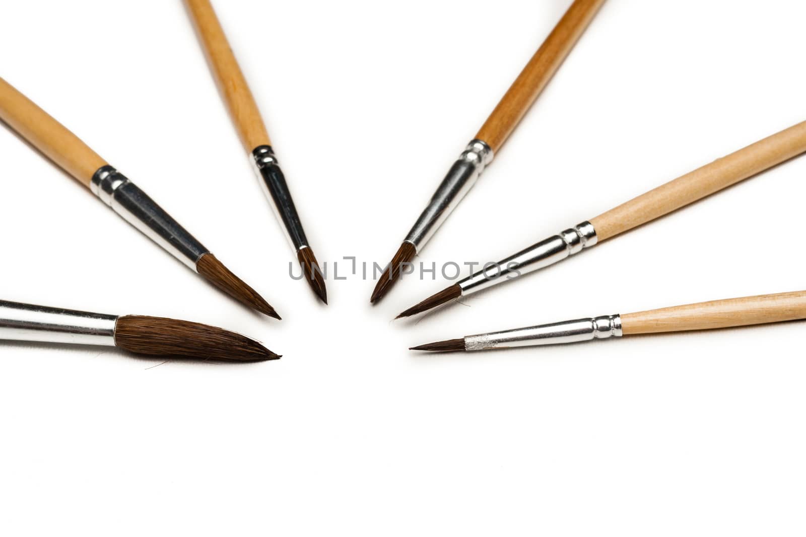 different size artist paint brushes on white