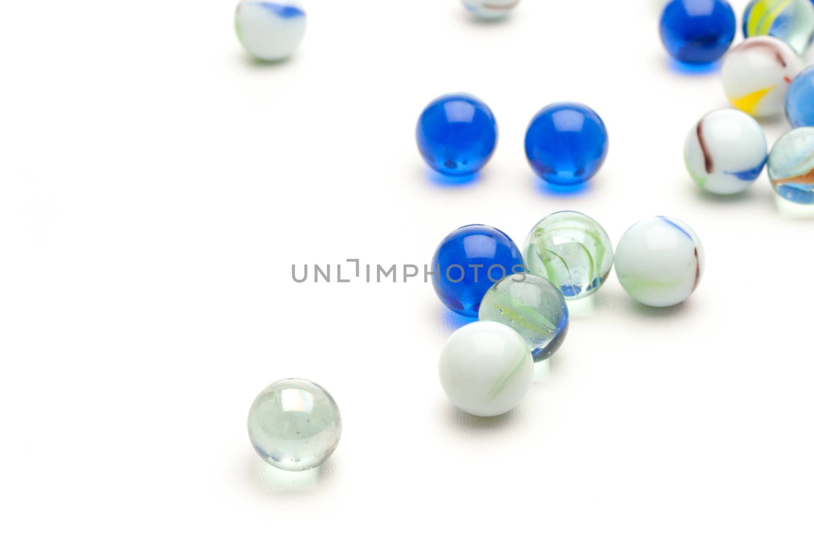 photo of different color marbles on white